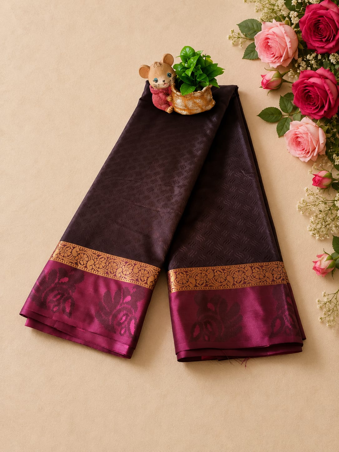 Authentic Kanchipuram silk saree featuring a deep aubergine/wine-colored body with a contrasting magenta border and traditional gold zari work.