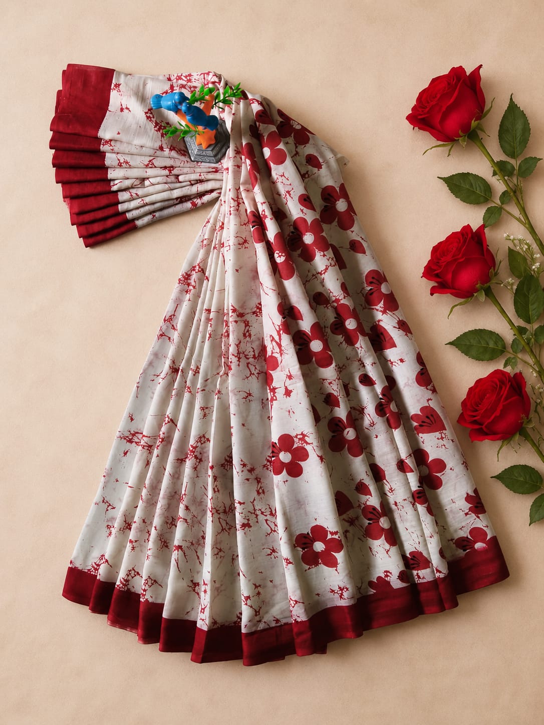 An elegant off-white and red floral print saree, beautifully accented