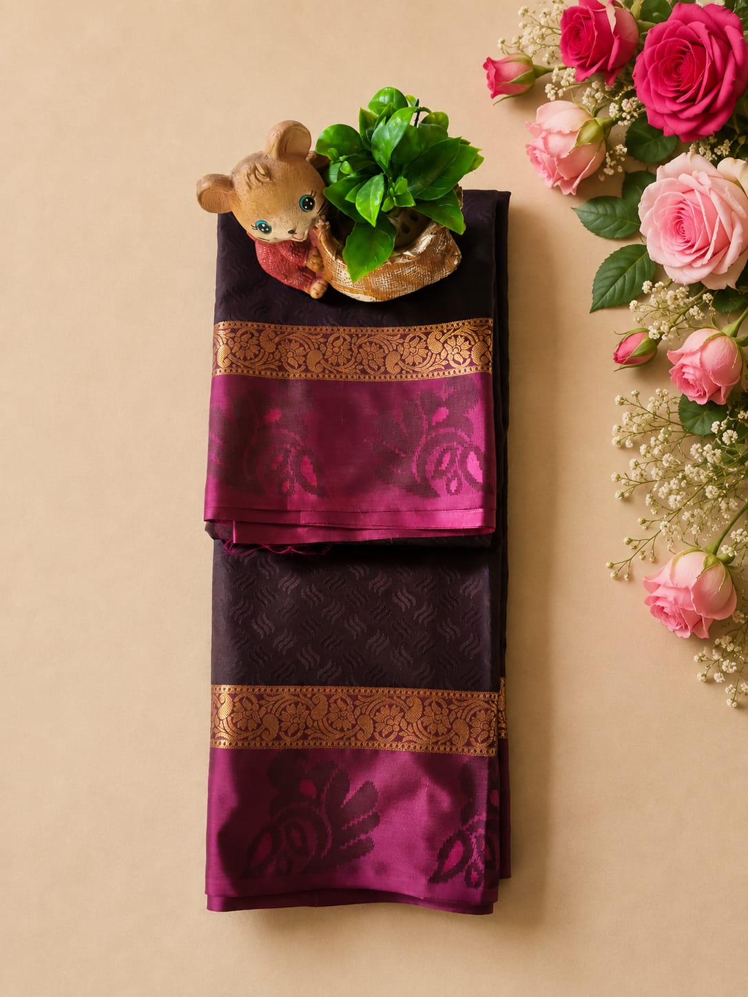 Authentic Kanchipuram silk saree featuring a deep aubergine/wine-colored body with a contrasting magenta border and traditional gold zari work.