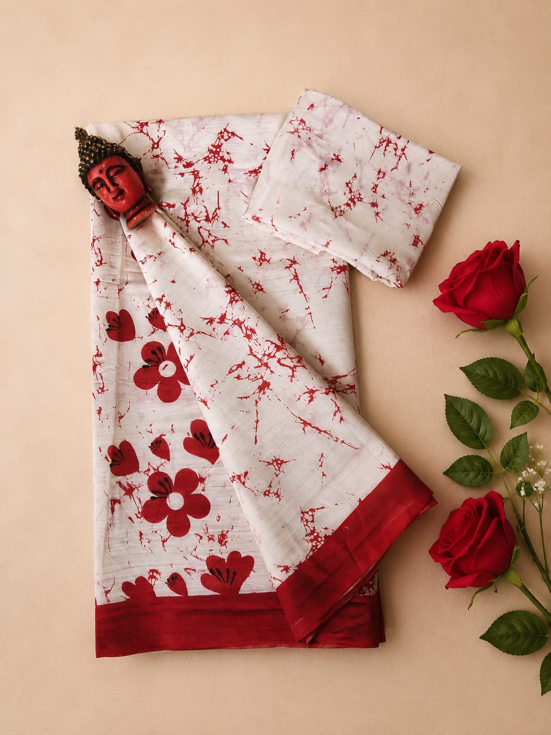 An elegant off-white and red floral print saree, beautifully accented