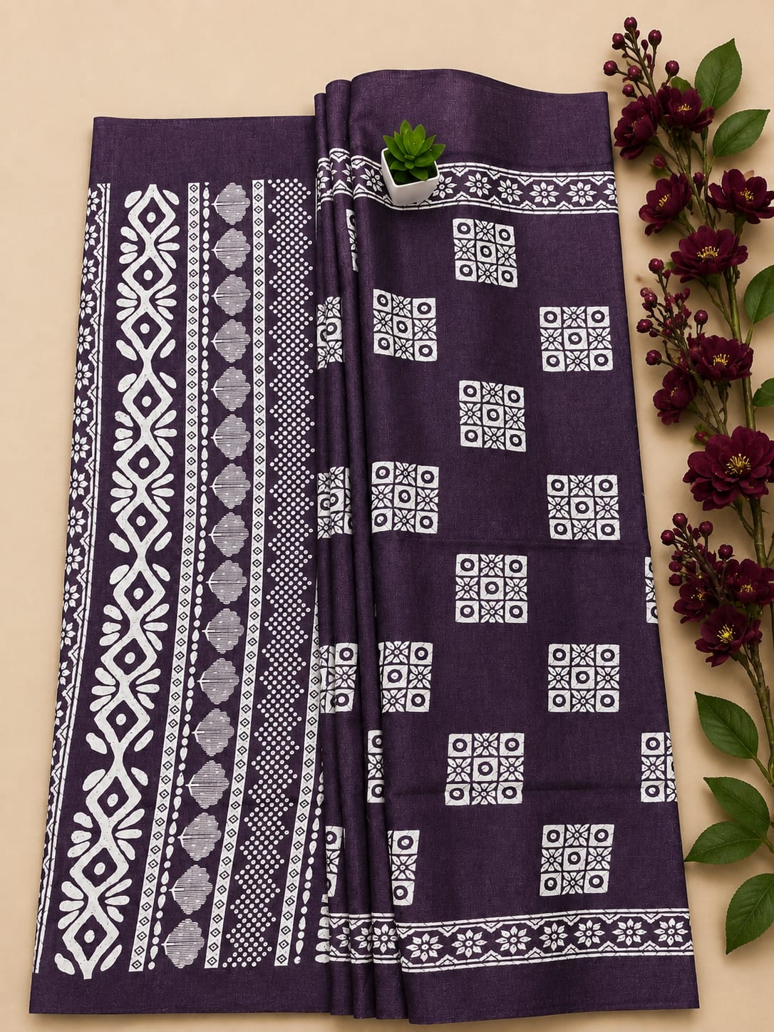 Stunning purple cotton dress material features intricate white block prints, including geometric patterns on the body and elaborate traditional motifs along the border